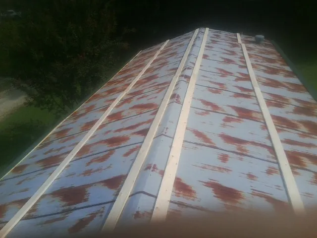 Rusted metal roof panels with new wood purlins before replacement — Storm Damage Roof Repair in Cape Neddick by Roofing Brothers