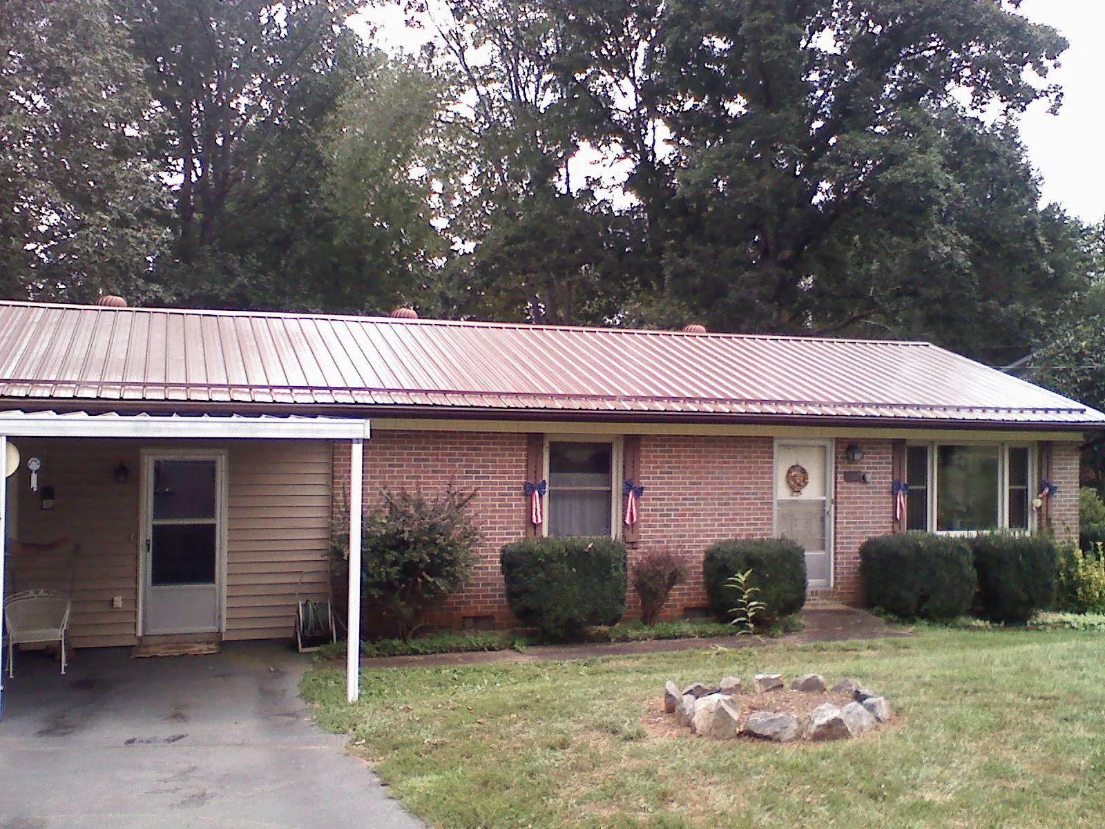 Bronze metal roof and carport on a brick ranch home — Roof Repair work by our crew in Cape Neddick